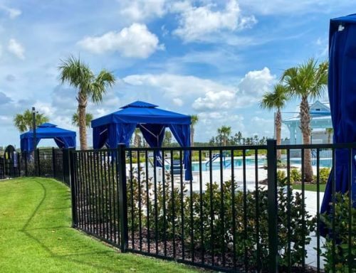 Black aluminum fence around a resort-style pool