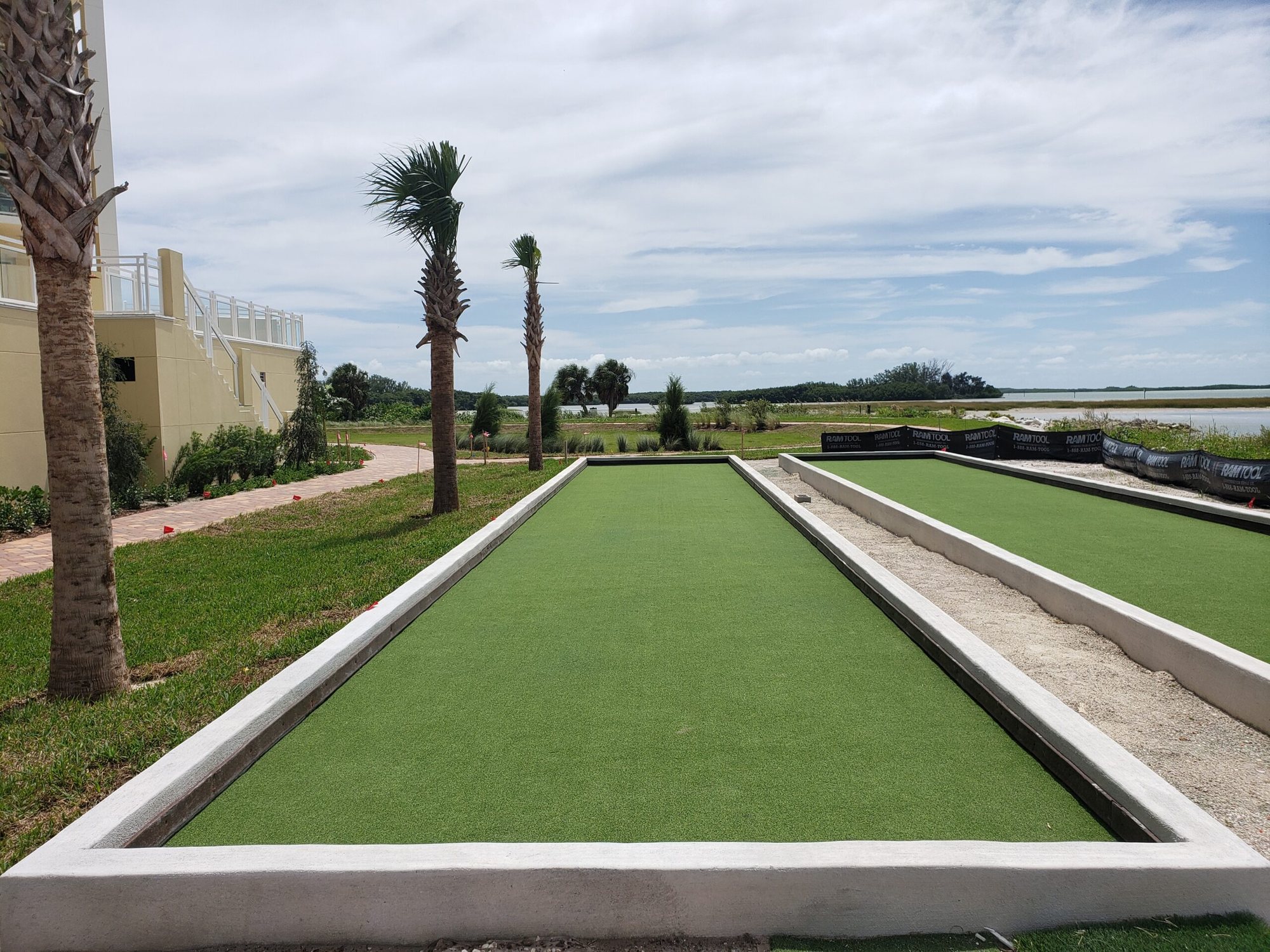Turf bocce lanes beside a community clubhouse