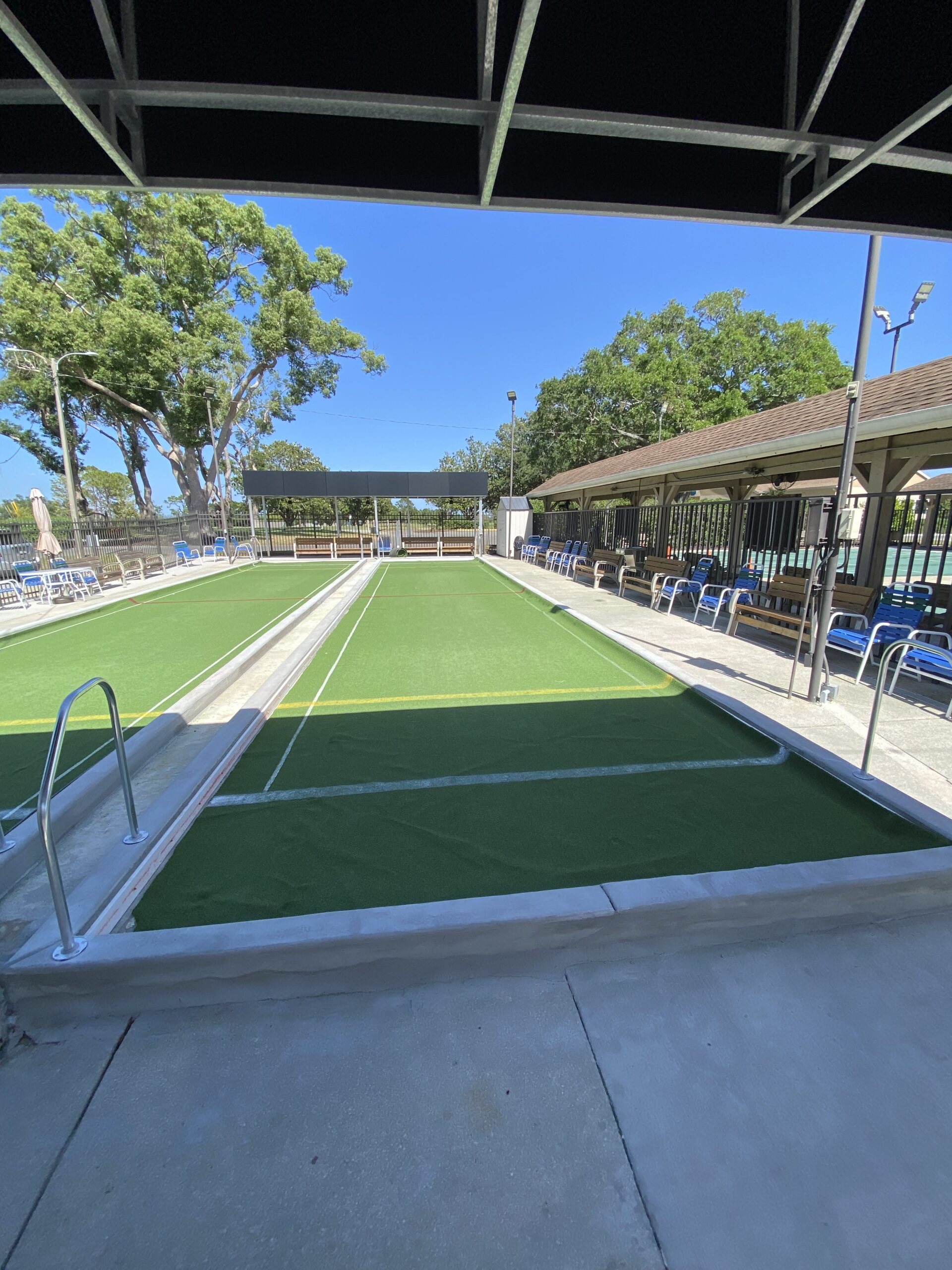 Covered turf bocce court at a community amenity center
