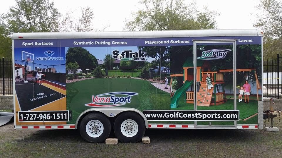 Golf Coast Sports branded equipment trailer showing turf, court and playground work