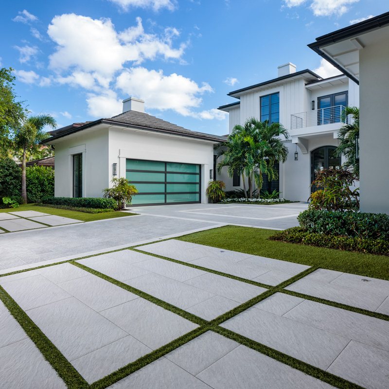 Concrete driveway slabs separated by turf ribbons at a modern home