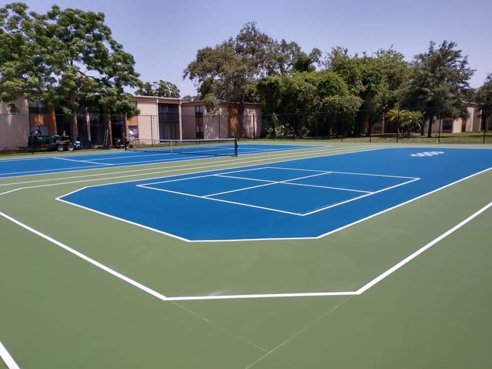 Blue and green community tennis court with white lines